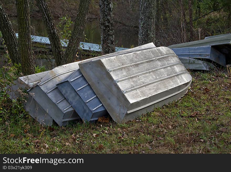 Aluminum row boats neatly stacked for winter storage. Aluminum row boats neatly stacked for winter storage.