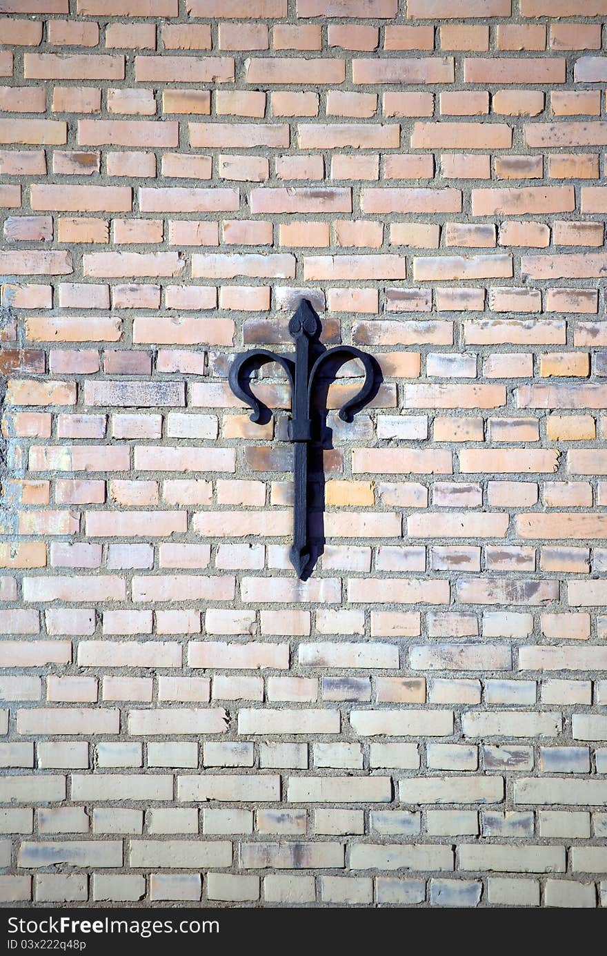 Anchor plate on exterior brick wall, for structural reinforcement with decorative style from year 1650