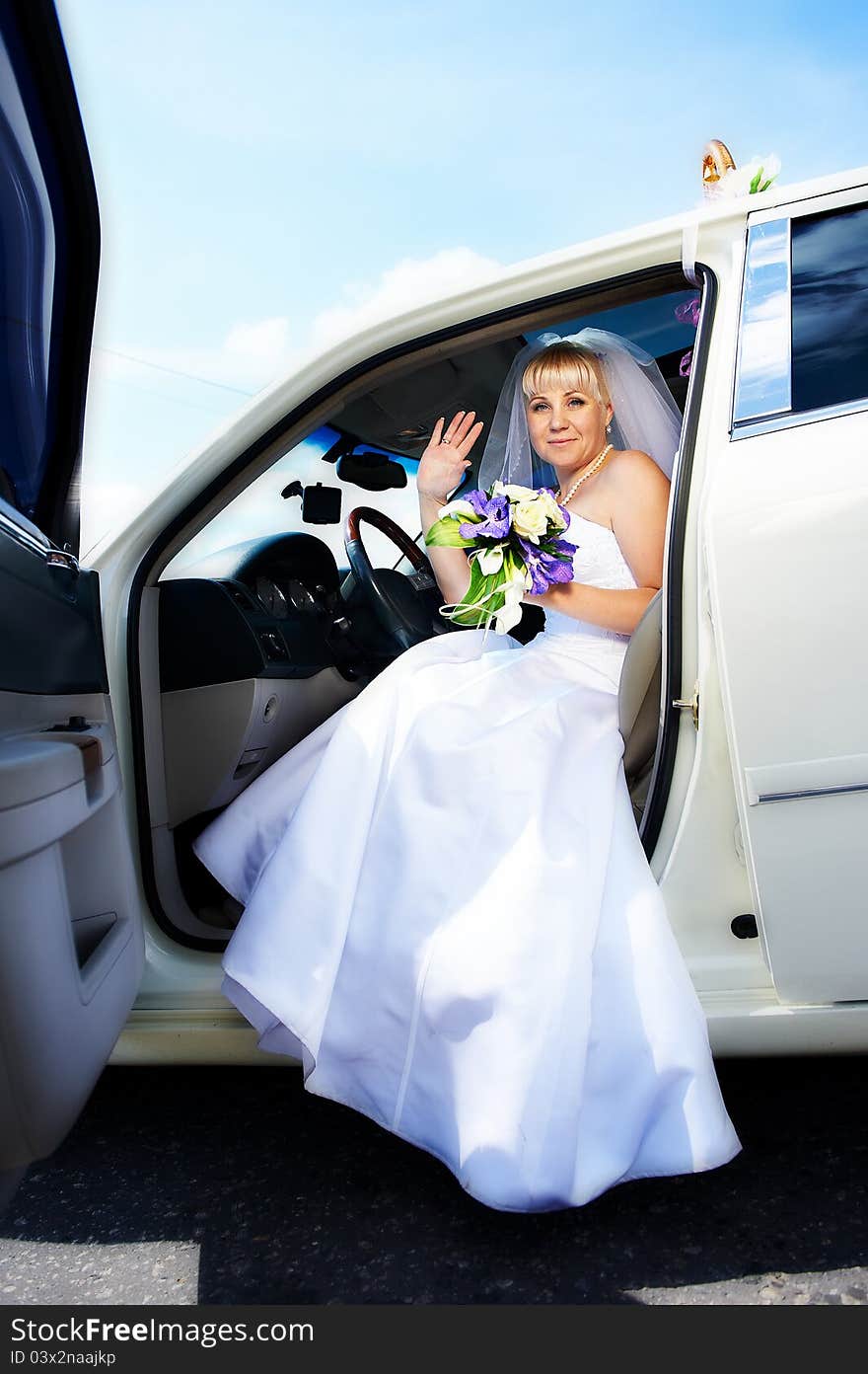 Happy bride waving in wedding limousine. Happy bride waving in wedding limousine