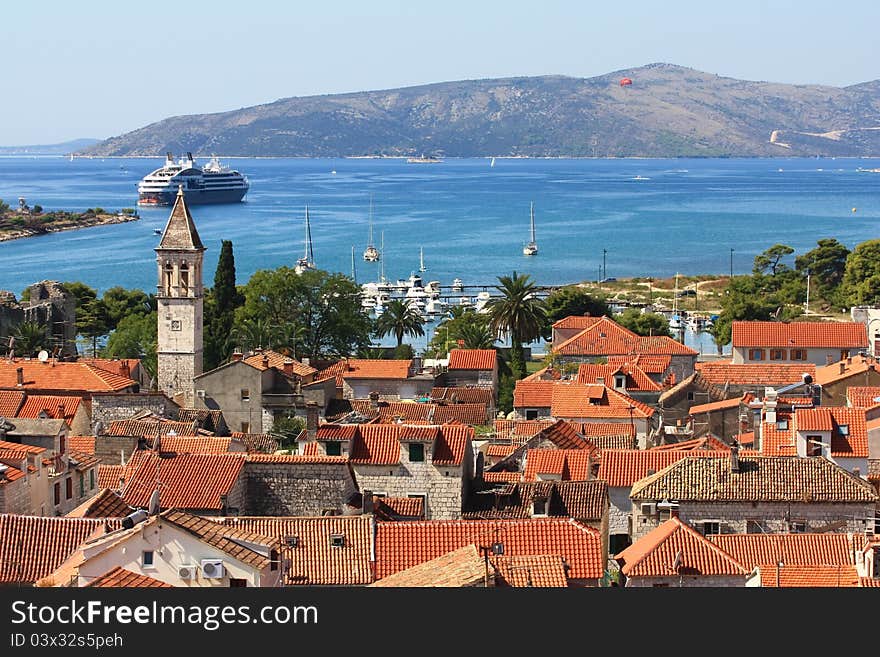 The view over the croatian town of trogir with its orange roofs and blue sea. The view over the croatian town of trogir with its orange roofs and blue sea