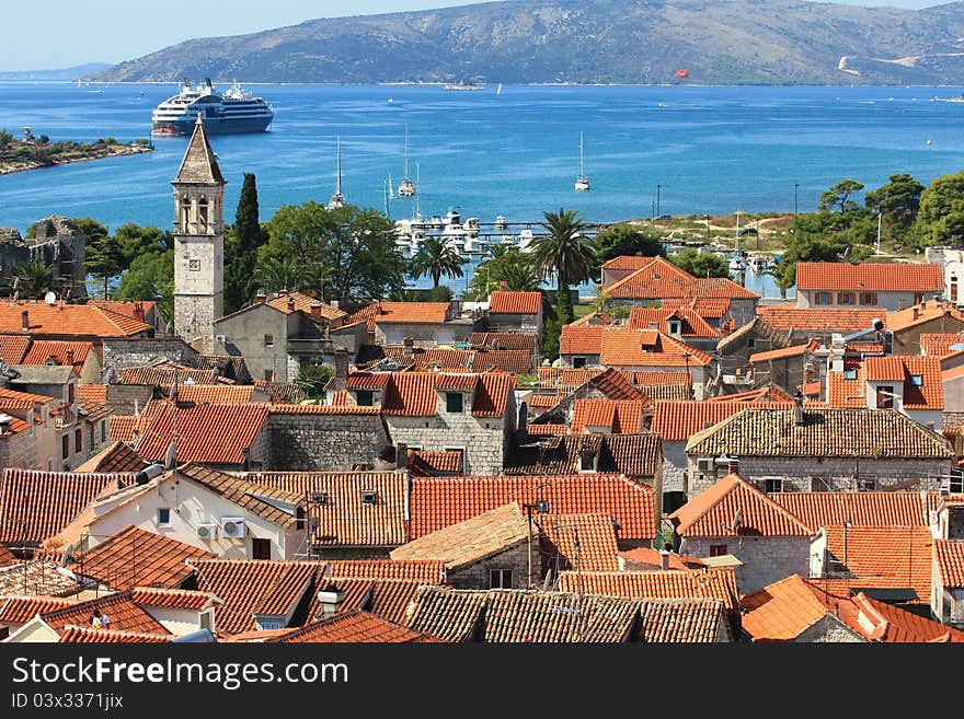 The view over the croatian town of trogir with its orange roofs and blue sea. The view over the croatian town of trogir with its orange roofs and blue sea