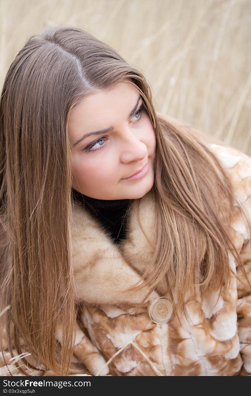 Young beautiful girl in a fur coat. Young beautiful girl in a fur coat