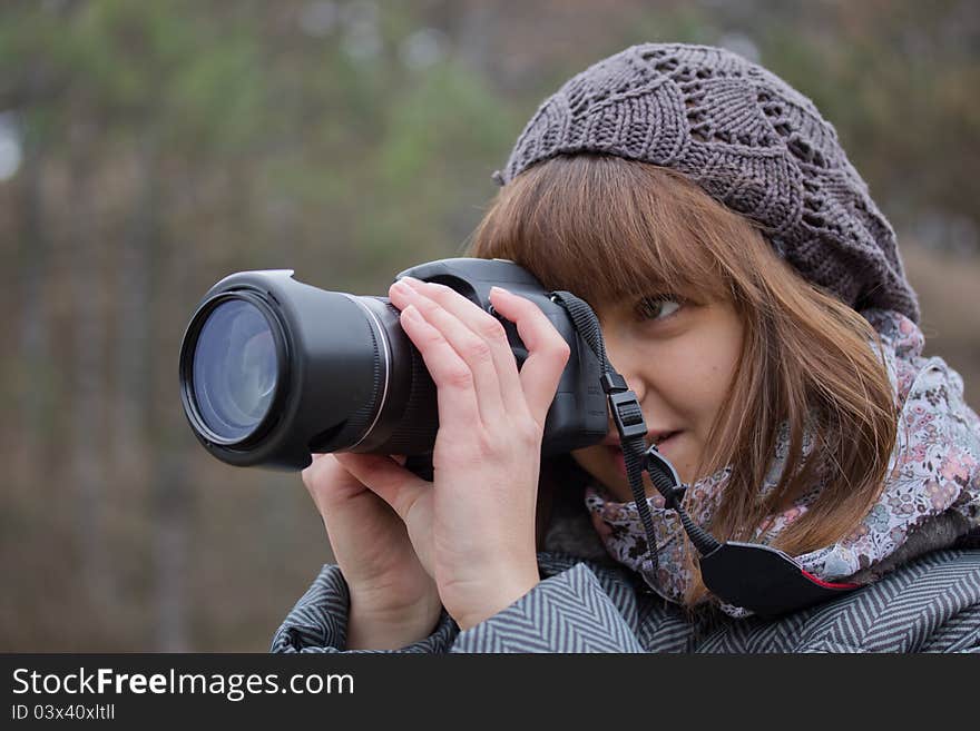 Young girl photographing something and smiles. Young girl photographing something and smiles