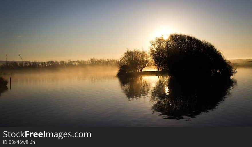 6:45 am, sun was rising highlights the mist and gives great reflections. 6:45 am, sun was rising highlights the mist and gives great reflections