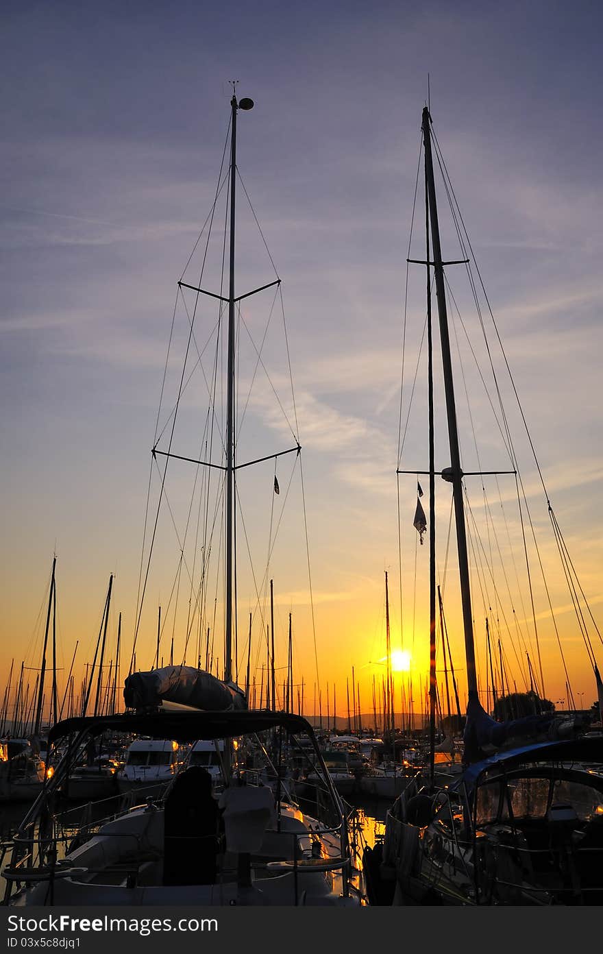 Marina and a forest of tall mast at sunset. Marina and a forest of tall mast at sunset