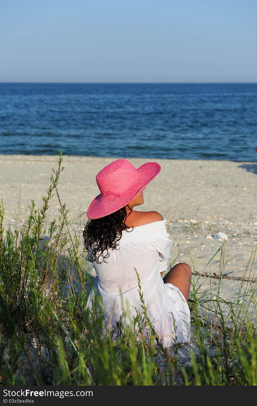 Young woman enjoying the sea view in summer evening. Young woman enjoying the sea view in summer evening