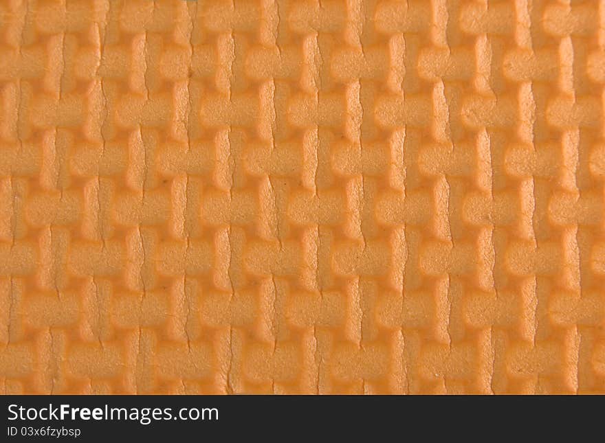 Orange woven rubber texture macro shot. Useful as background for design. Orange woven rubber texture macro shot. Useful as background for design.