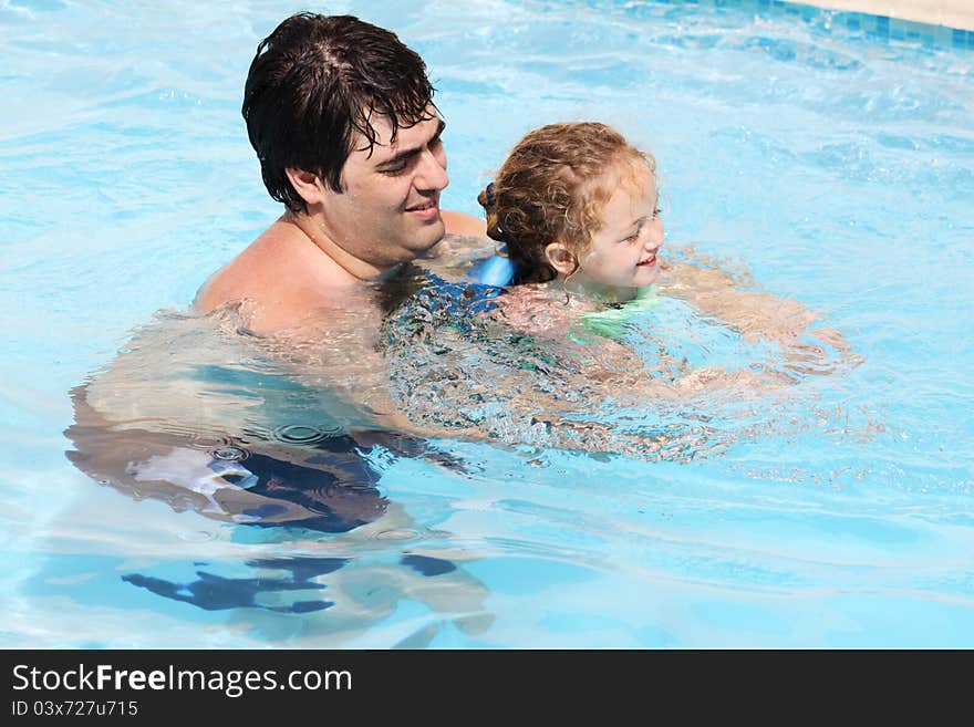 Daddy teaching daughter how to swim. Daddy teaching daughter how to swim