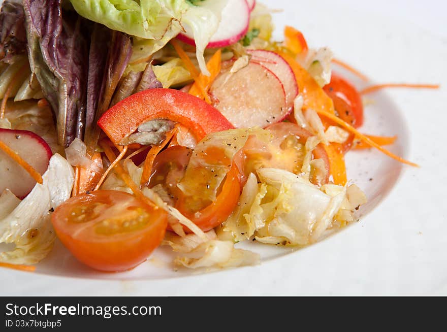 Green vegetables salad on white plate