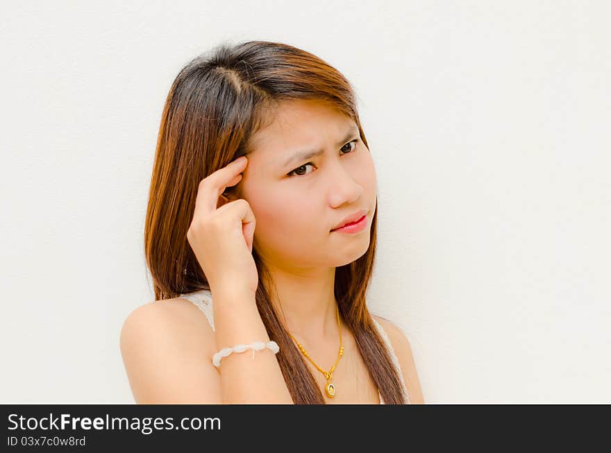 Young cute asian girl feel a bit headache on white background. Young cute asian girl feel a bit headache on white background