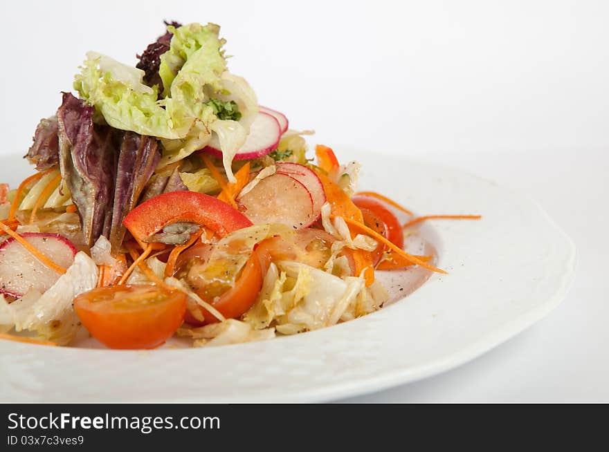 Green vegetables salad on white plate. Green vegetables salad on white plate