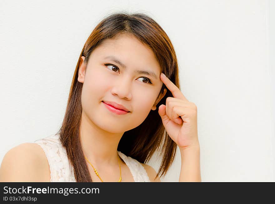 Young cute asian girl thinking on white background