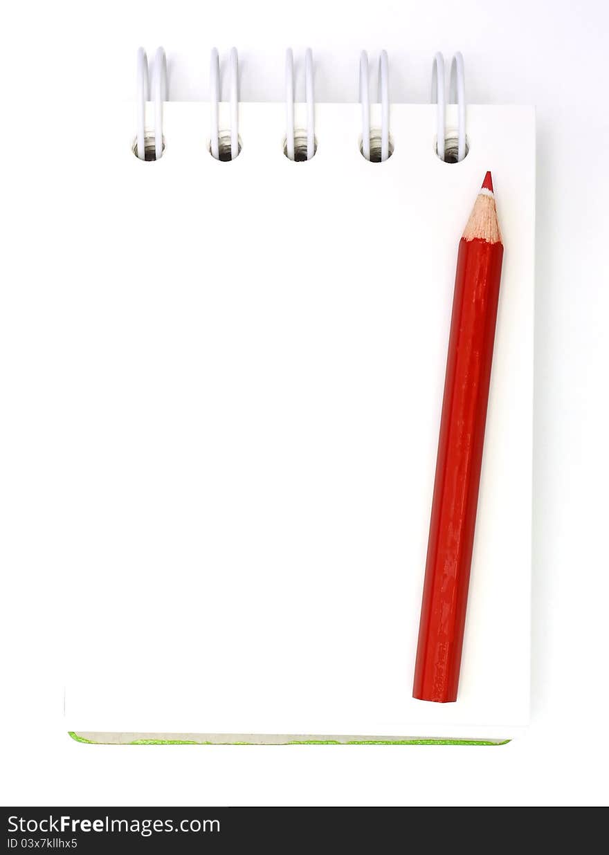 Note book and red pencil on white