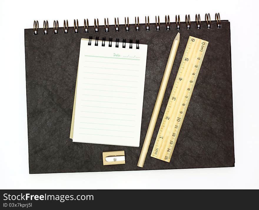 School accessories and notebooks on white background