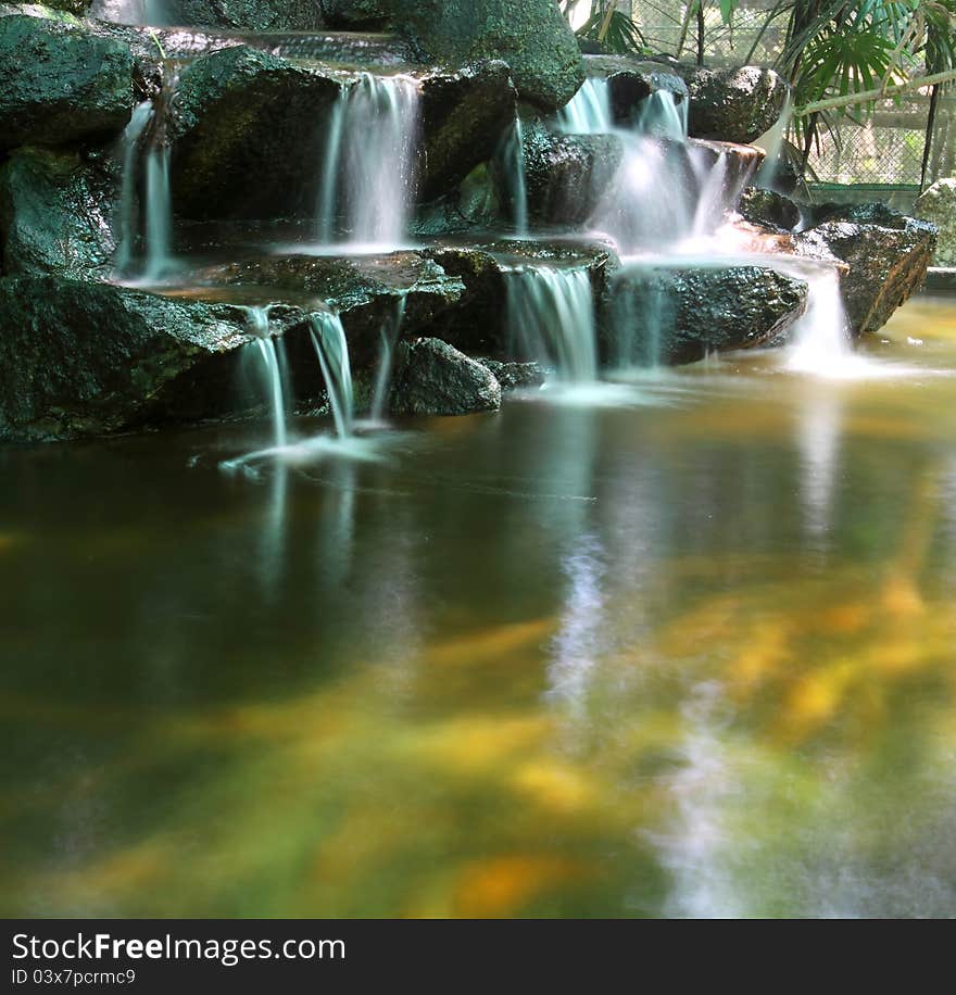 Koi fish pond with waterfalls in the zoo