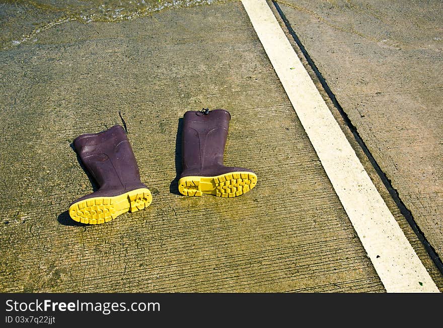 High boots on textured concrete. High boots on textured concrete.