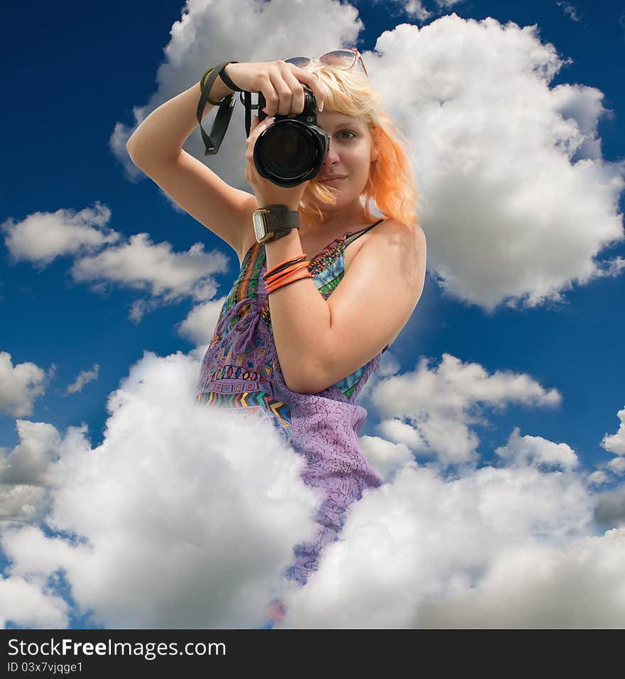 Blond-haired woman taking a photo with a camera. Blond-haired woman taking a photo with a camera