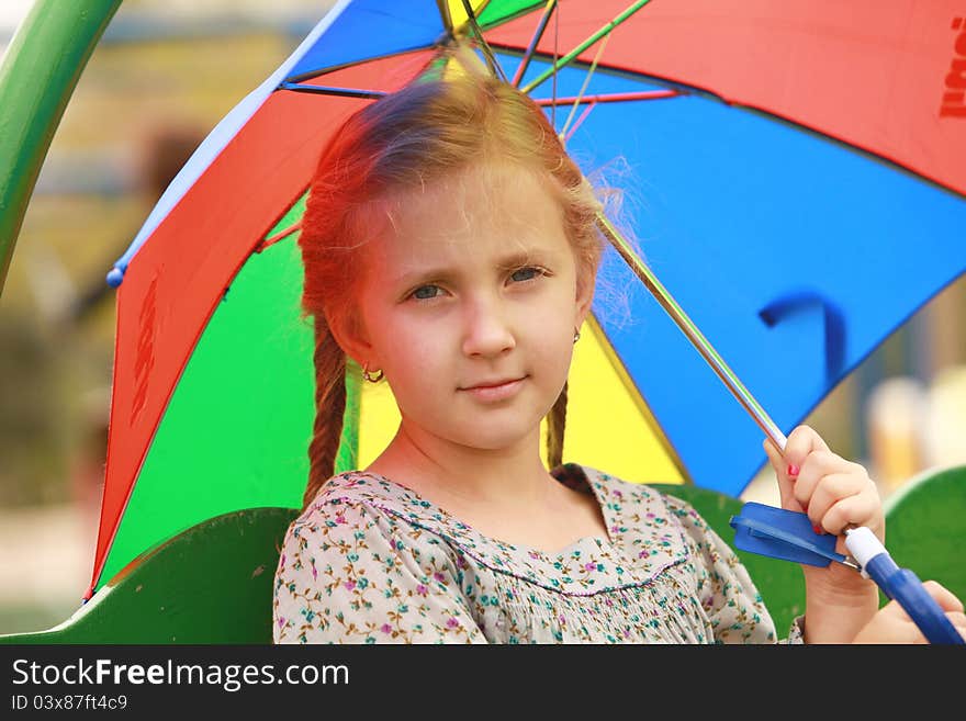 Portrait of little girl with an umbrella