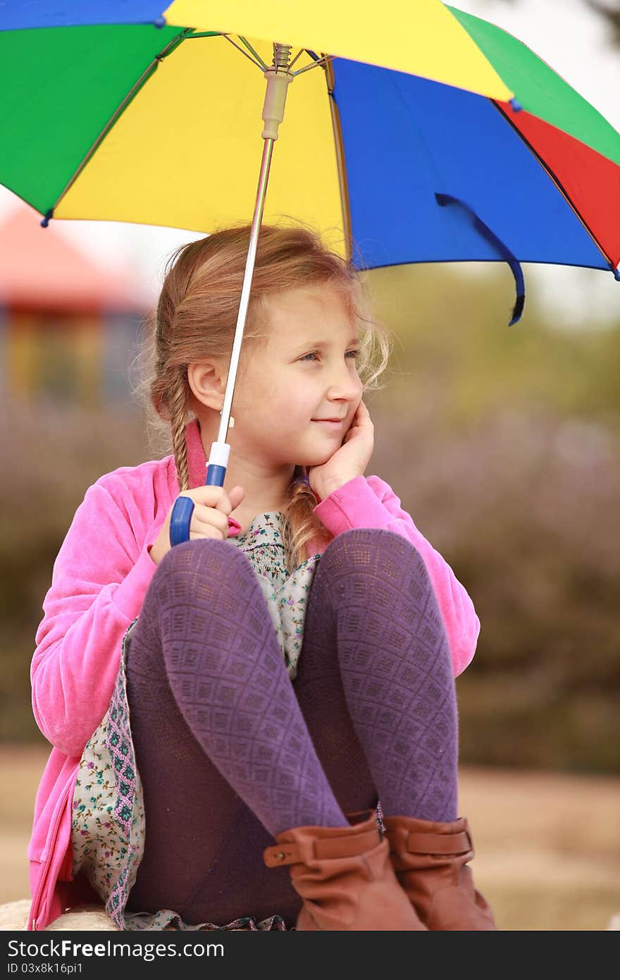 Portrait Of Little Girl With An Color Umbrella