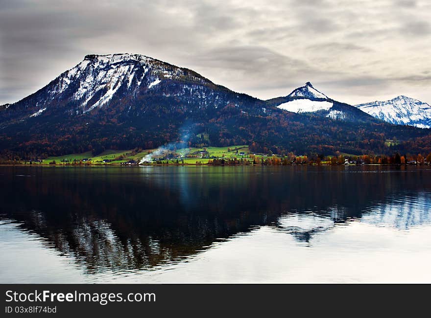 Dramatic view on the lake and Alps reflected in it in Salzburg, Austria. Dramatic view on the lake and Alps reflected in it in Salzburg, Austria