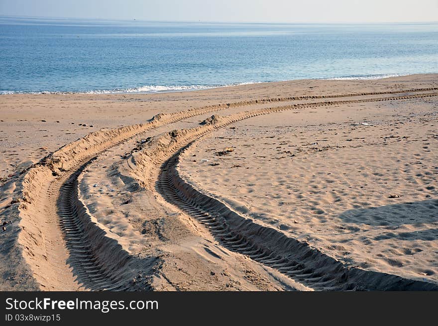 Tractor wheel trace in the sand on the beach. Tractor wheel trace in the sand on the beach