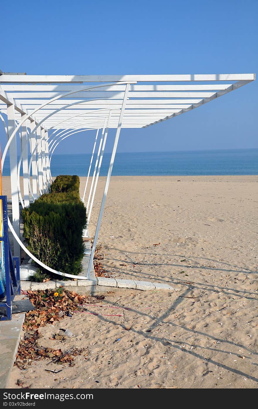 White metallic sun shelter on empty beach. White metallic sun shelter on empty beach