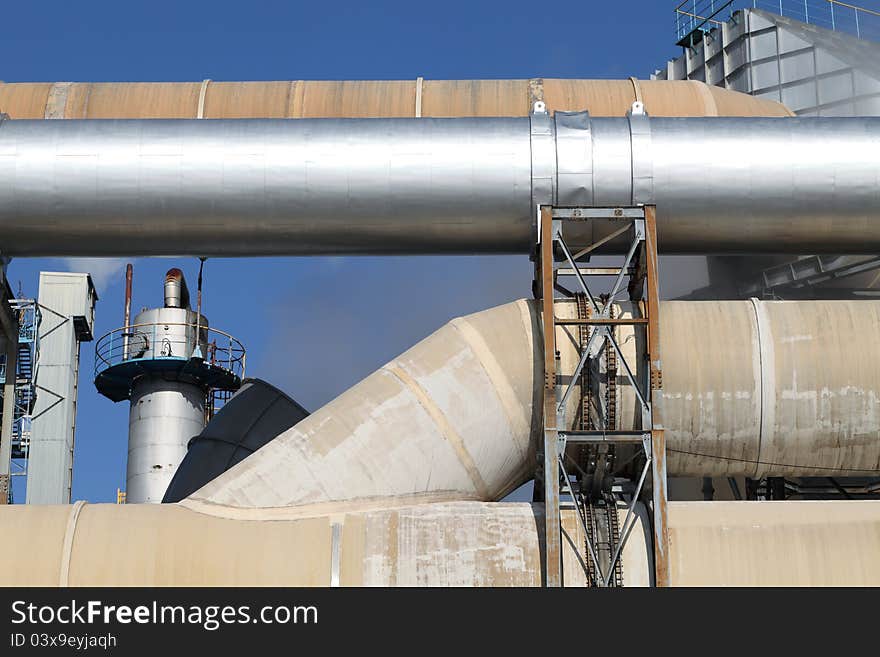 Industrial pipelines against blue sky