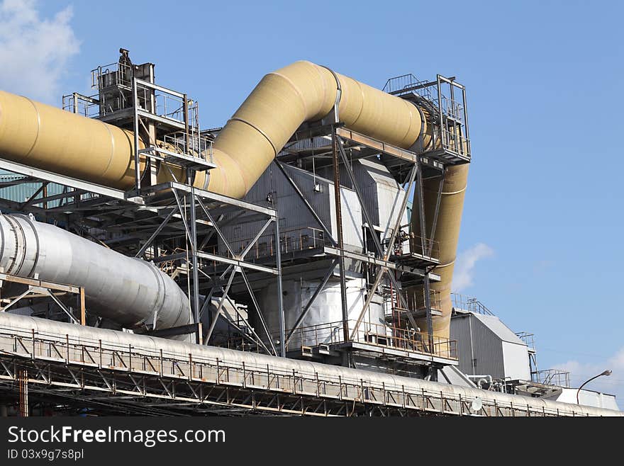 Industrial pipelines against blue sky