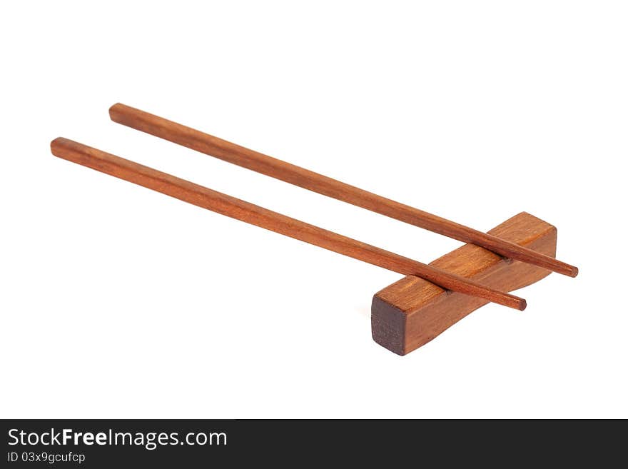 Wooden chopsticks on a stand, on a white background