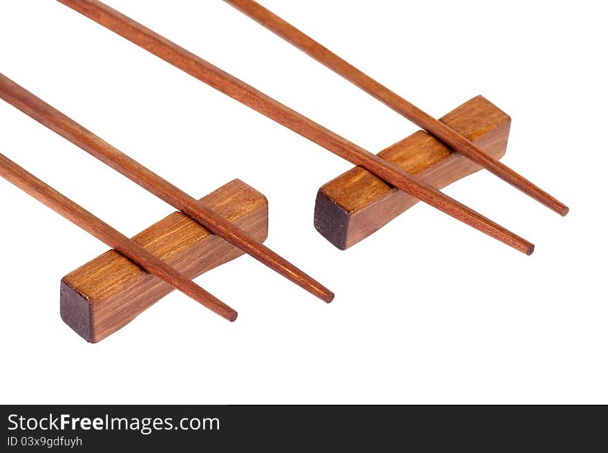 Wooden chopsticks on a stand, on a white background