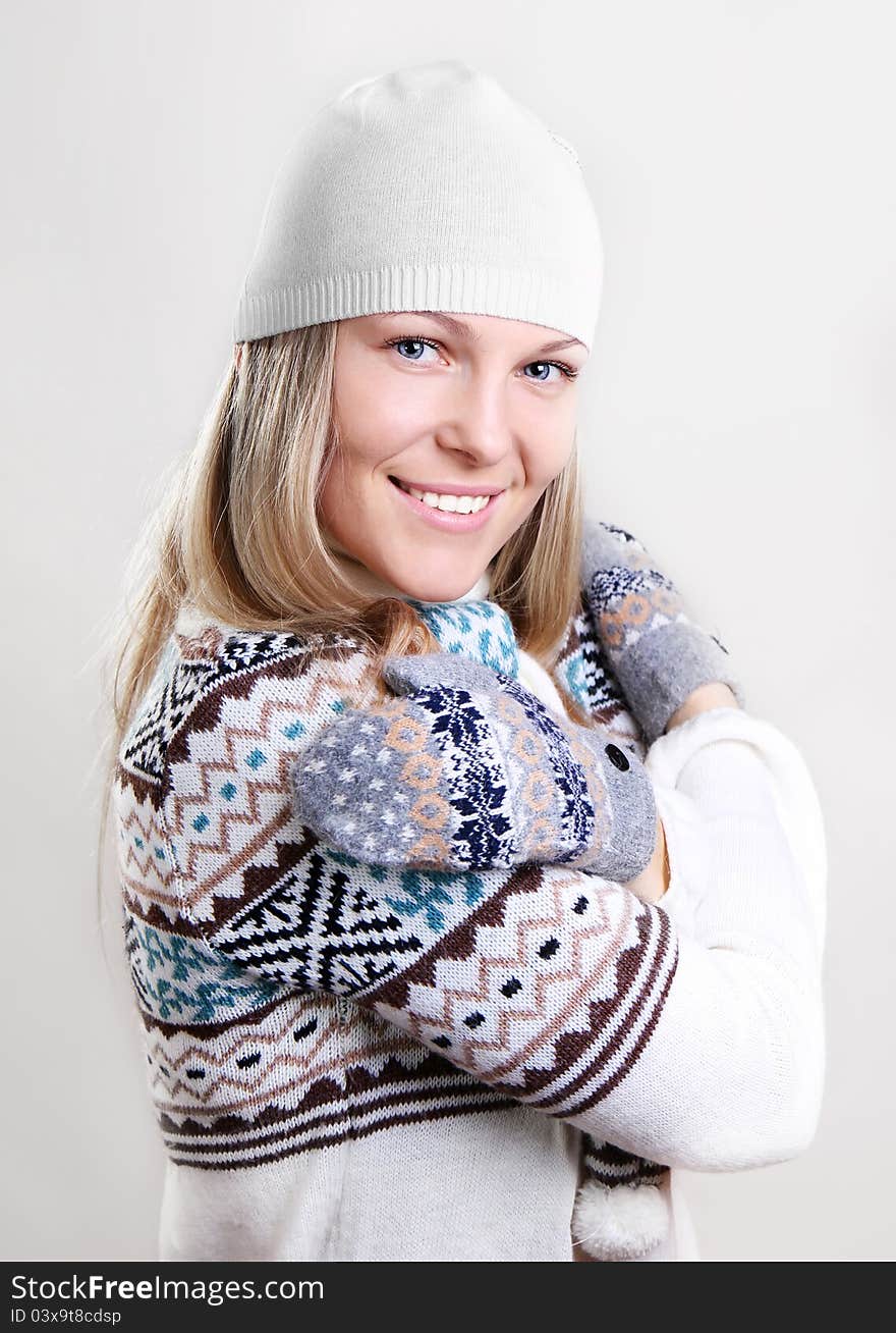 Beautiful young smiling woman in a knitted sweater. Beautiful young smiling woman in a knitted sweater