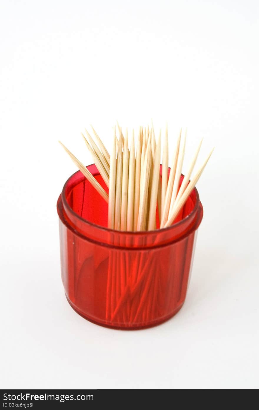 Toothpicks in red box on white background