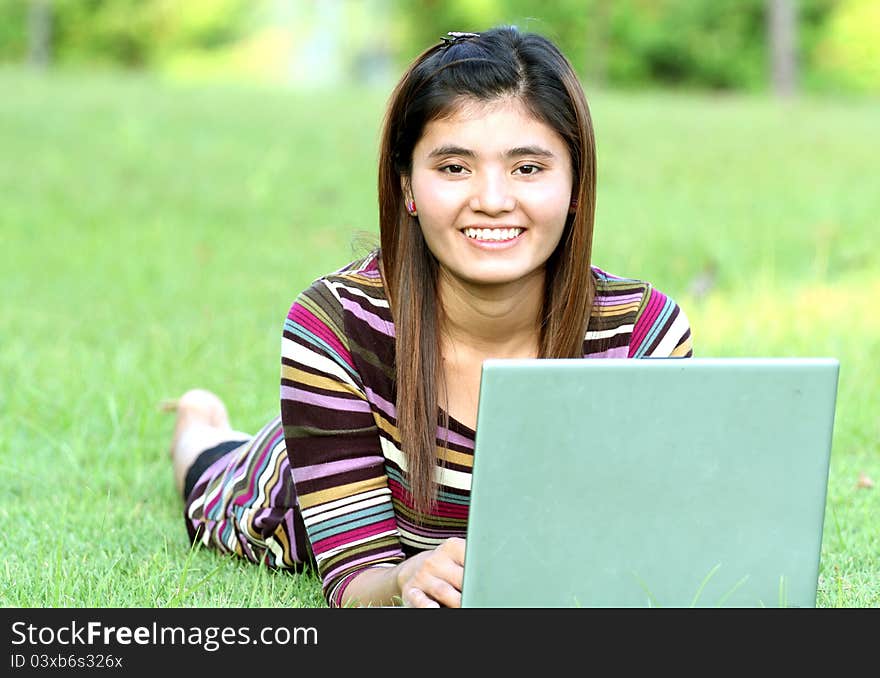 Asian female college student studying with a laptop computer. Asian female college student studying with a laptop computer