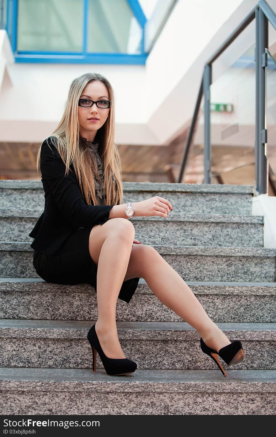 Woman sits on the stairs