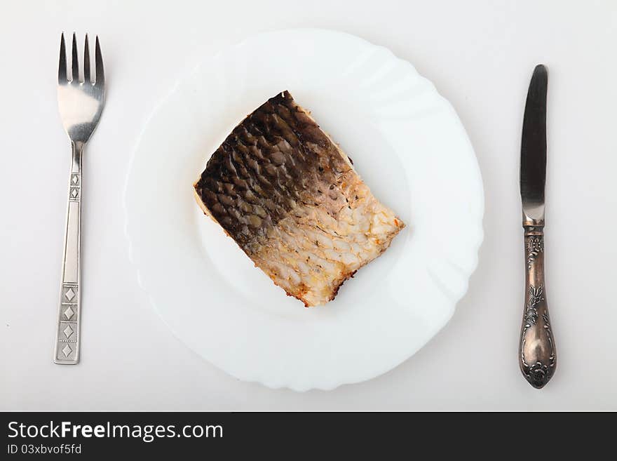 Fish in white plate . Fish in white plate .