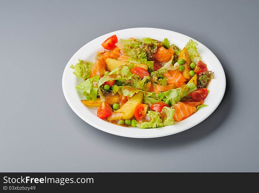 Salmon salad with potato, tomato and pea