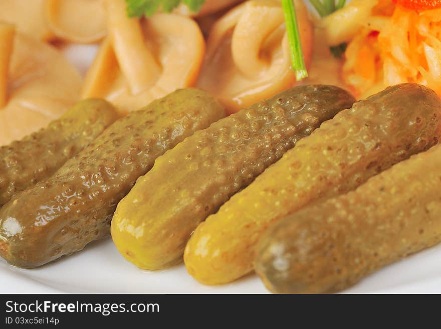 Marinated cucumbers and mushrooms on plate. Marinated cucumbers and mushrooms on plate