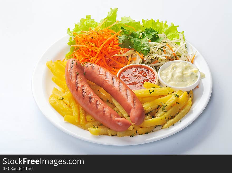 Grilled sausage with potato tomato sause and salad. Grilled sausage with potato tomato sause and salad