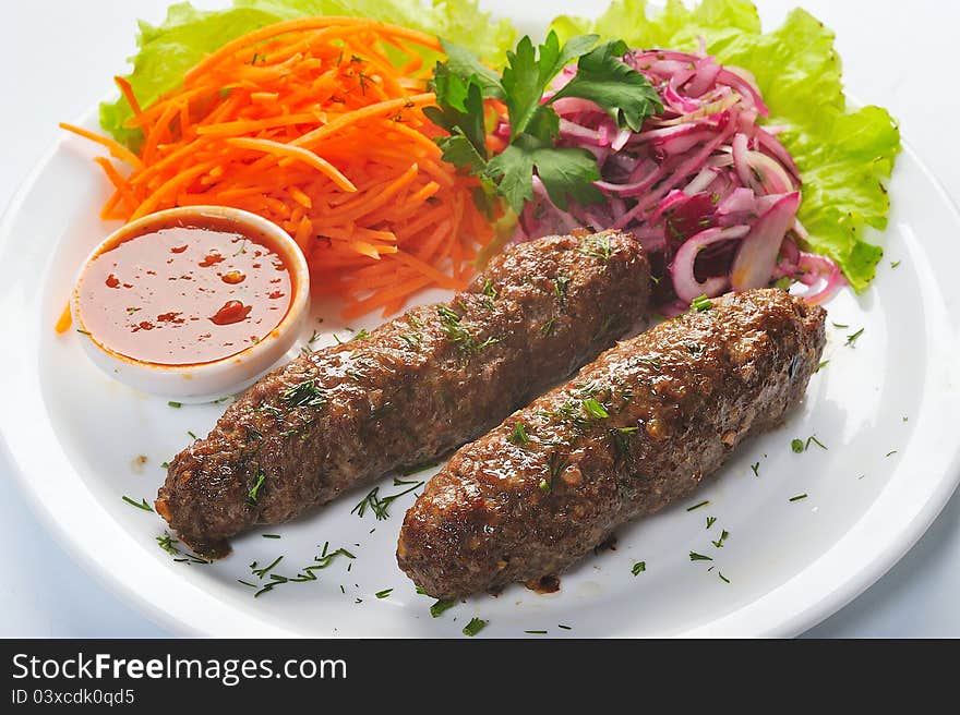 Baked kotlets with onion, sauce, carrot. Baked kotlets with onion, sauce, carrot