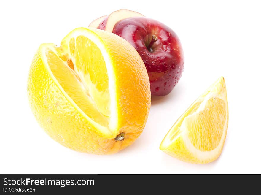 Cut orange and sliced red apple isolated on white screen. Cut orange and sliced red apple isolated on white screen.