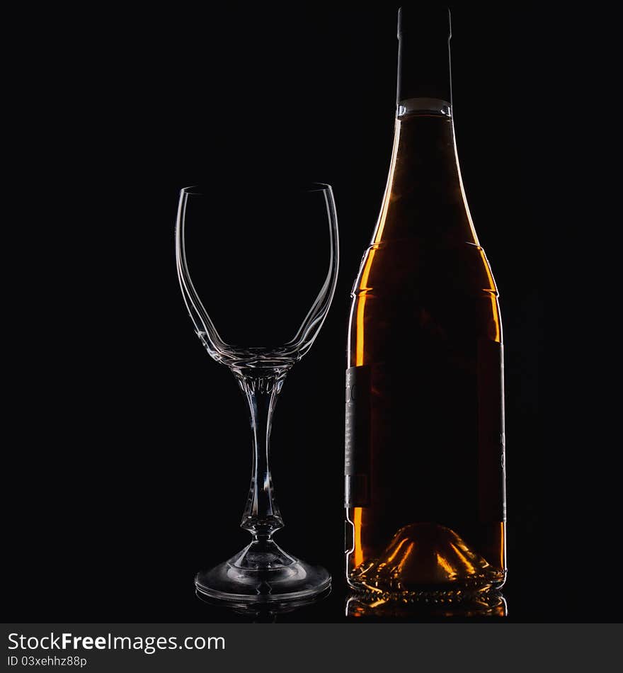 Wine Glass  and Wine Bottle over dark background