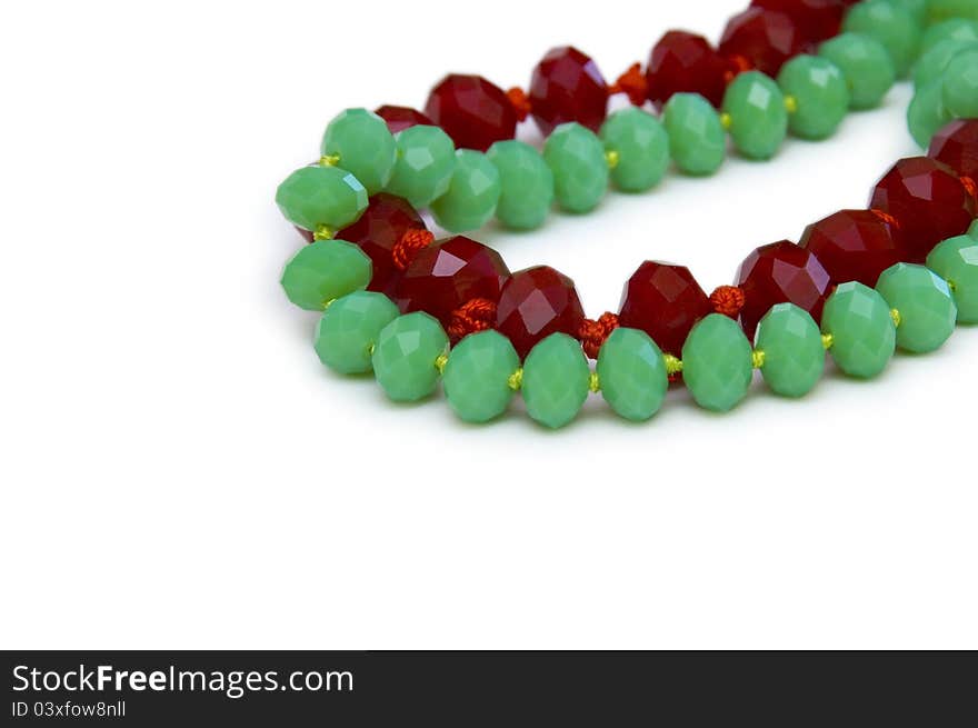 Necklace made of green and red beads isolated on white. Necklace made of green and red beads isolated on white