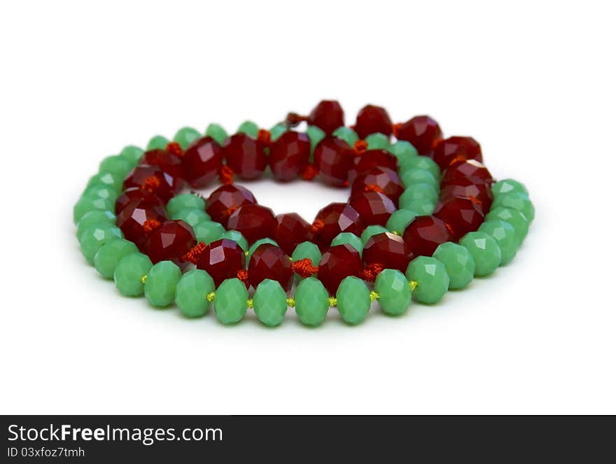 Necklace made of green and red beads isolated on white. Necklace made of green and red beads isolated on white