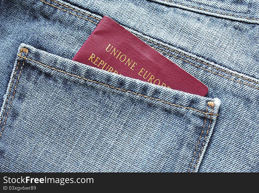 Italian passport in a traveller's jeans back pocket. Italian passport in a traveller's jeans back pocket