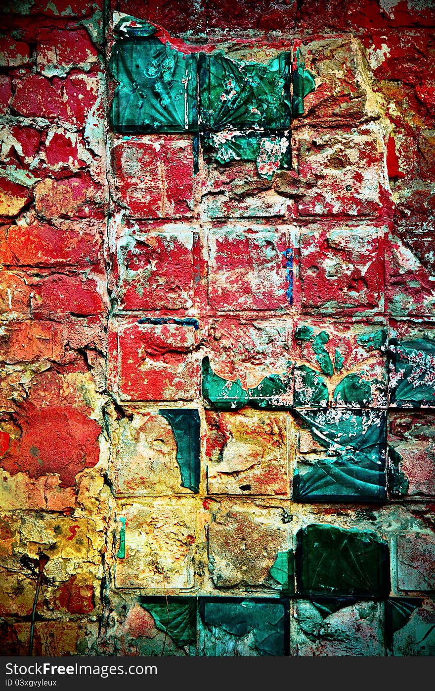 Background in style grunge. Multi-colored wall with a beaten tile of green color