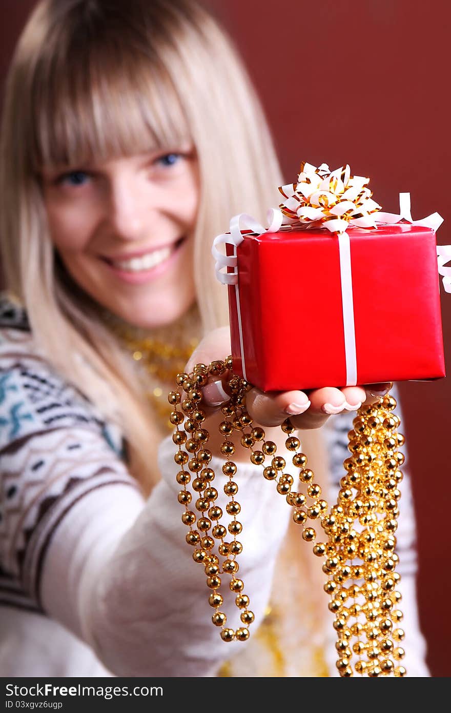 Beautiful woman gives a Christmas gift. Beautiful woman gives a Christmas gift