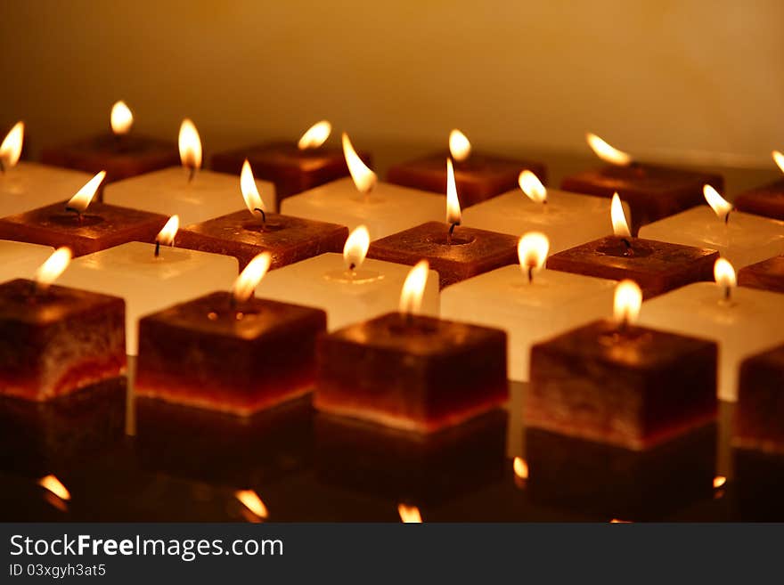 Group of brown and white candles creating spa atmosphere. Group of brown and white candles creating spa atmosphere