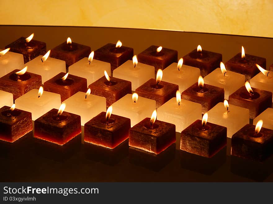 Group of brown and white candles creating peaceful atmosphere. Group of brown and white candles creating peaceful atmosphere