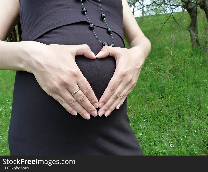 Beautiful pregnant devusha walks in spring park