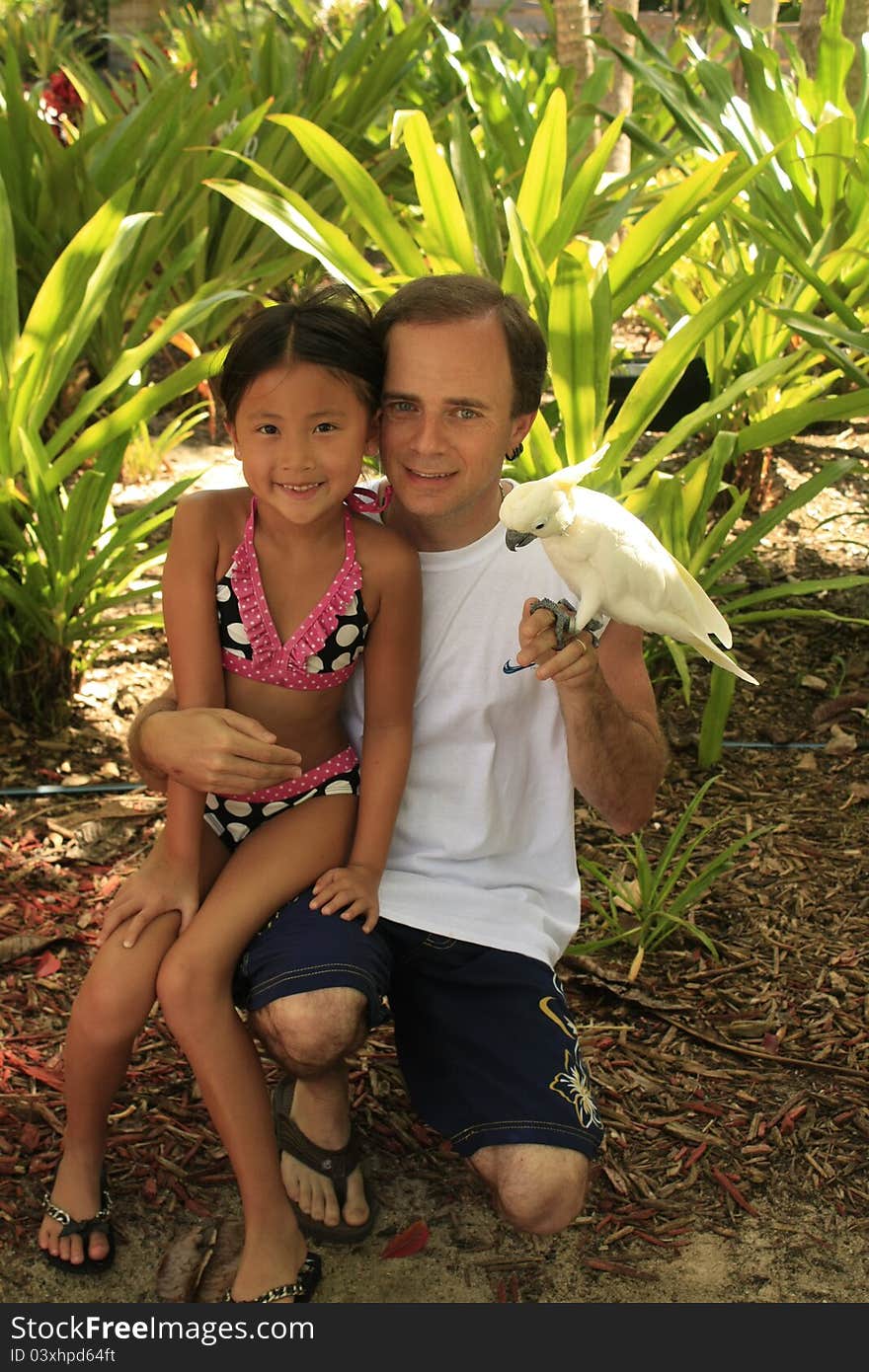 Little girl with dad holding a bird. Little girl with dad holding a bird